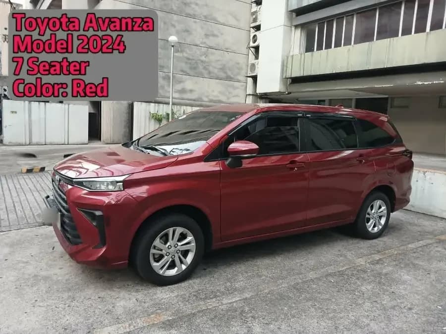 Red 2024 Toyota Avanza seven-seater parked beside a building