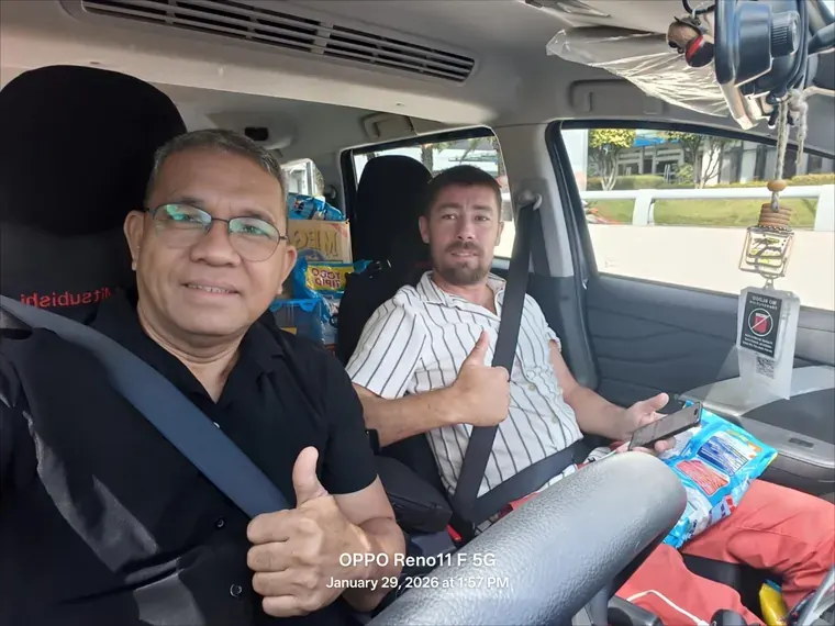 Cris Labastida at the wheel of the Mitsubishi Xpander with guest Thomas T beside him, both giving a thumbs up